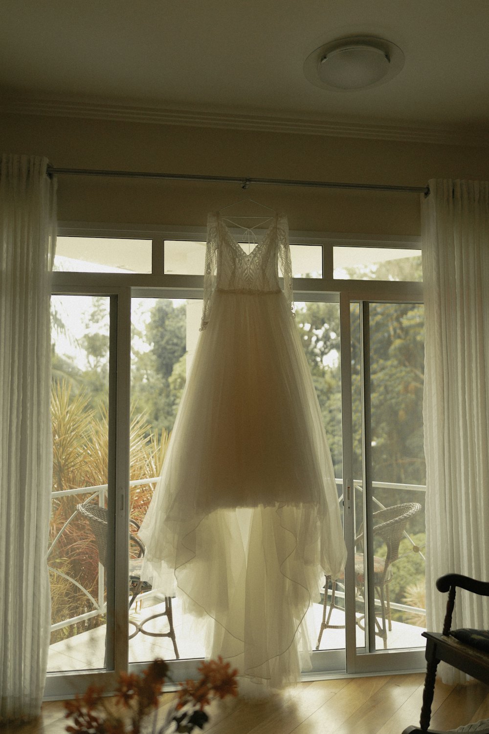Gown hanging by a tall window