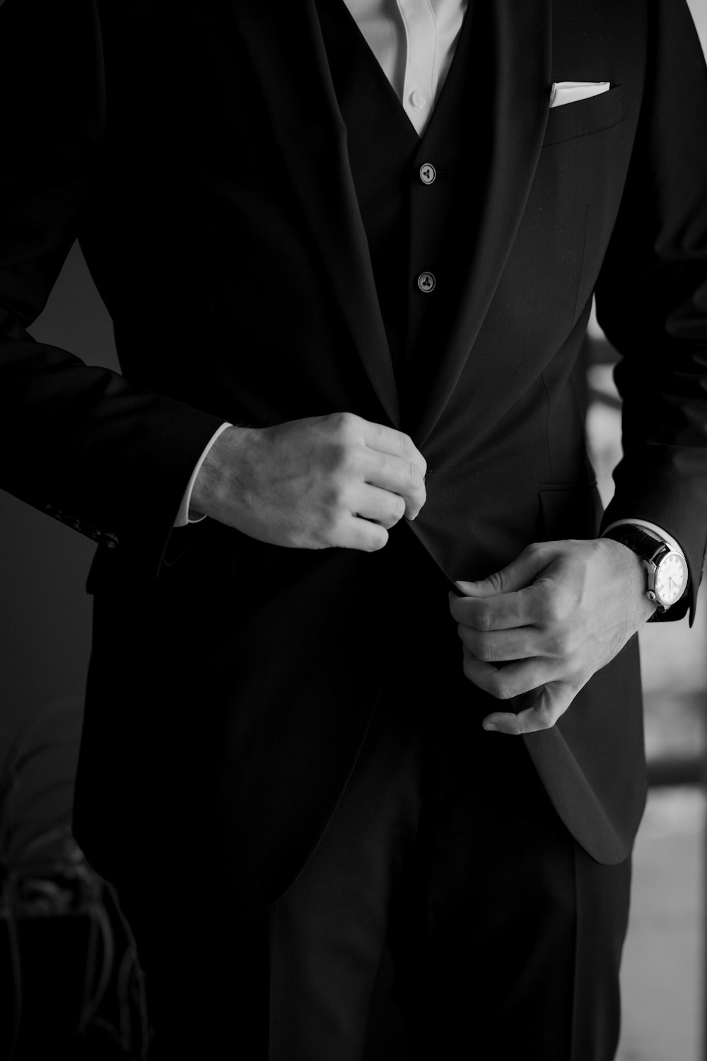 Groom fastening his jacket