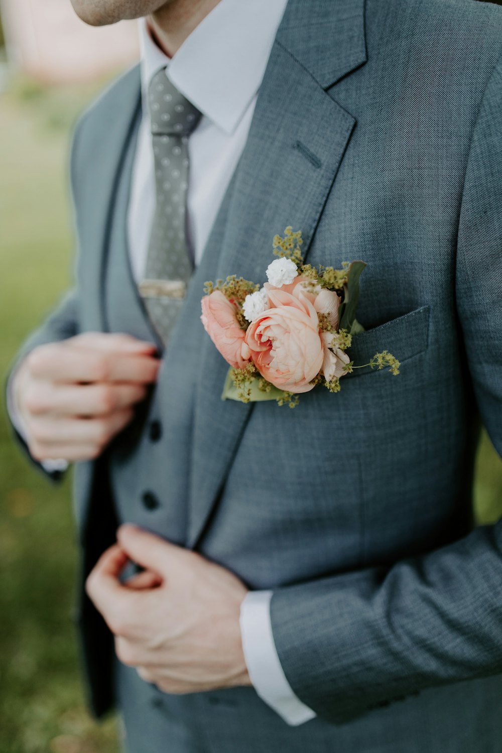 Groom in a grey suit with a buttonhole