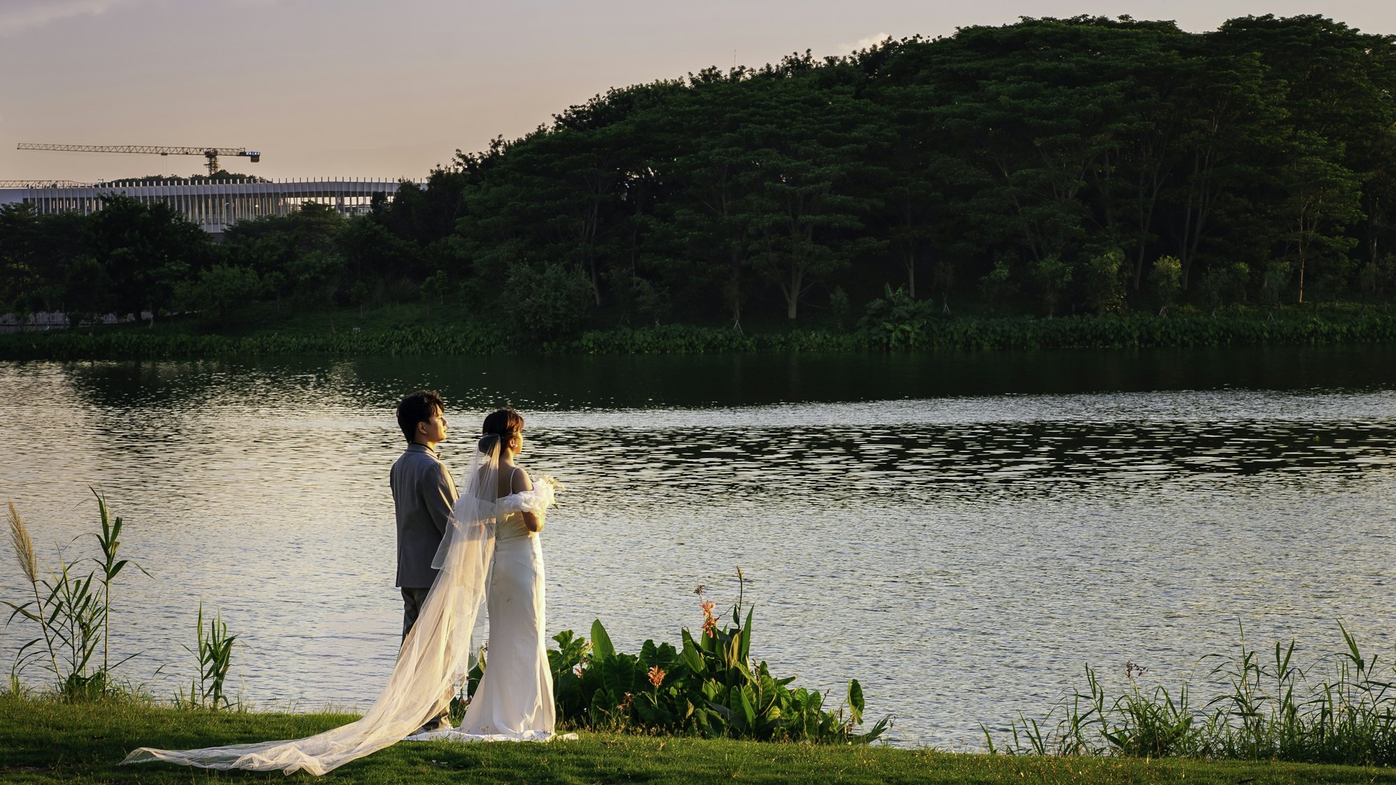 Couple standing beside a calm lake